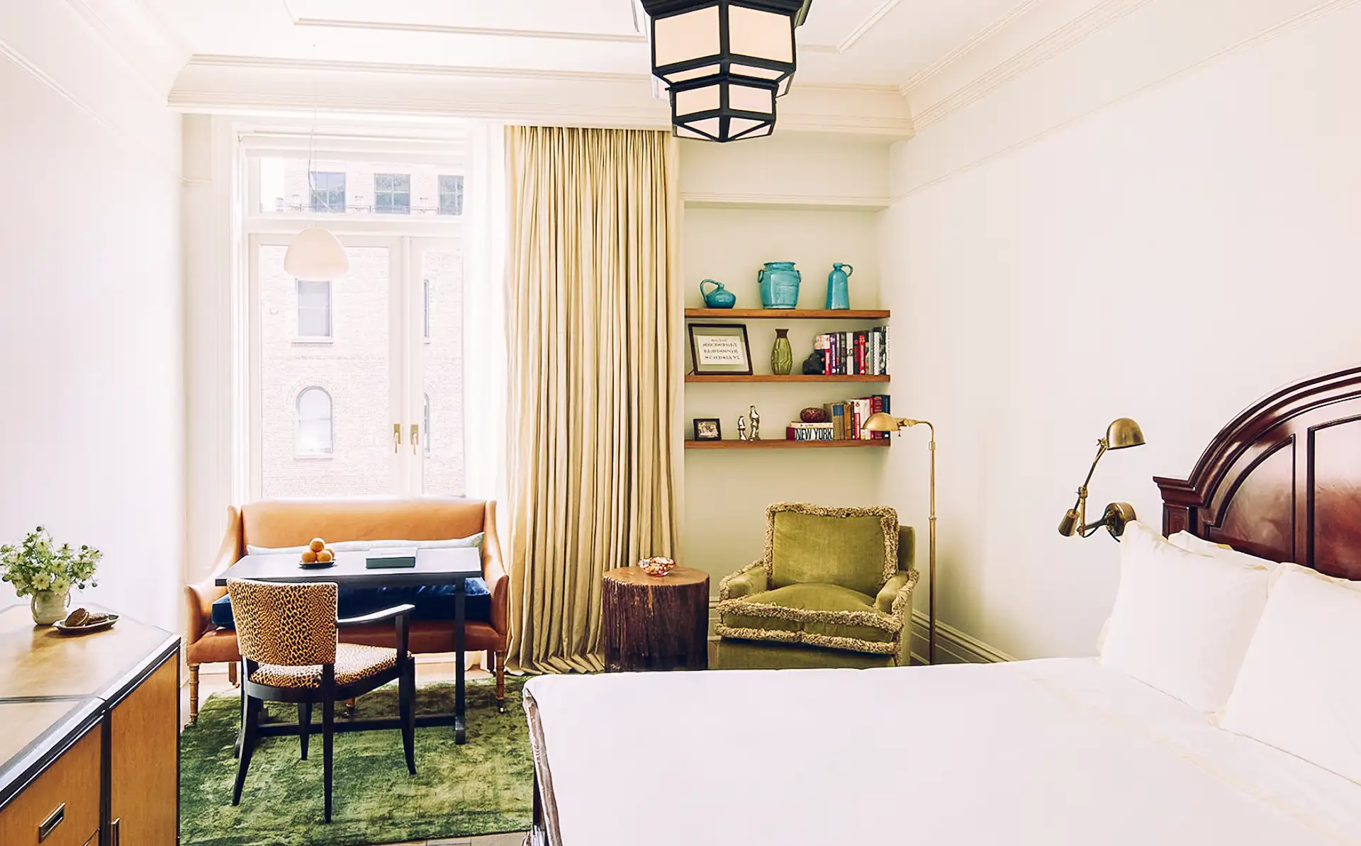 Superior room bed in the foreground with sitting area in the background