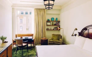 Superior room bed in the foreground with sitting area in the background
