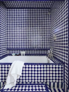 Blue and white tiled alcove soaking tub