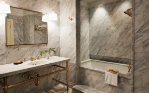 A marble bathroom with alcove soaking tub, vanity and mirror above the vanity