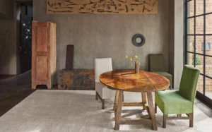 A round wood table with two different dining chairs