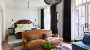 Looking over the sofa at the king bed inside the studio suite.