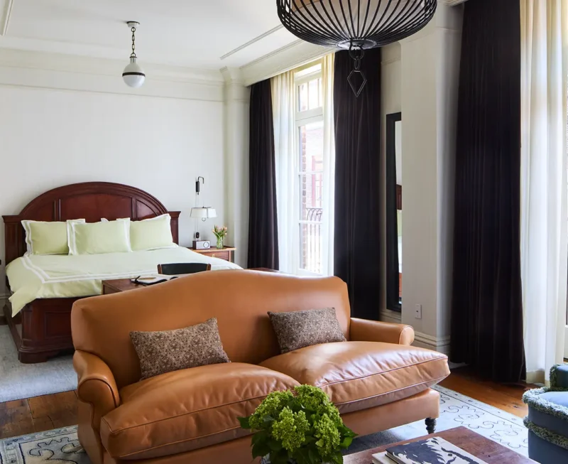 Looking over the sofa at the king bed inside the studio suite.