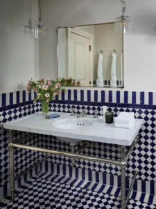 Marble Vanity and blue and white tile in a bathroom at the greenwich hotel