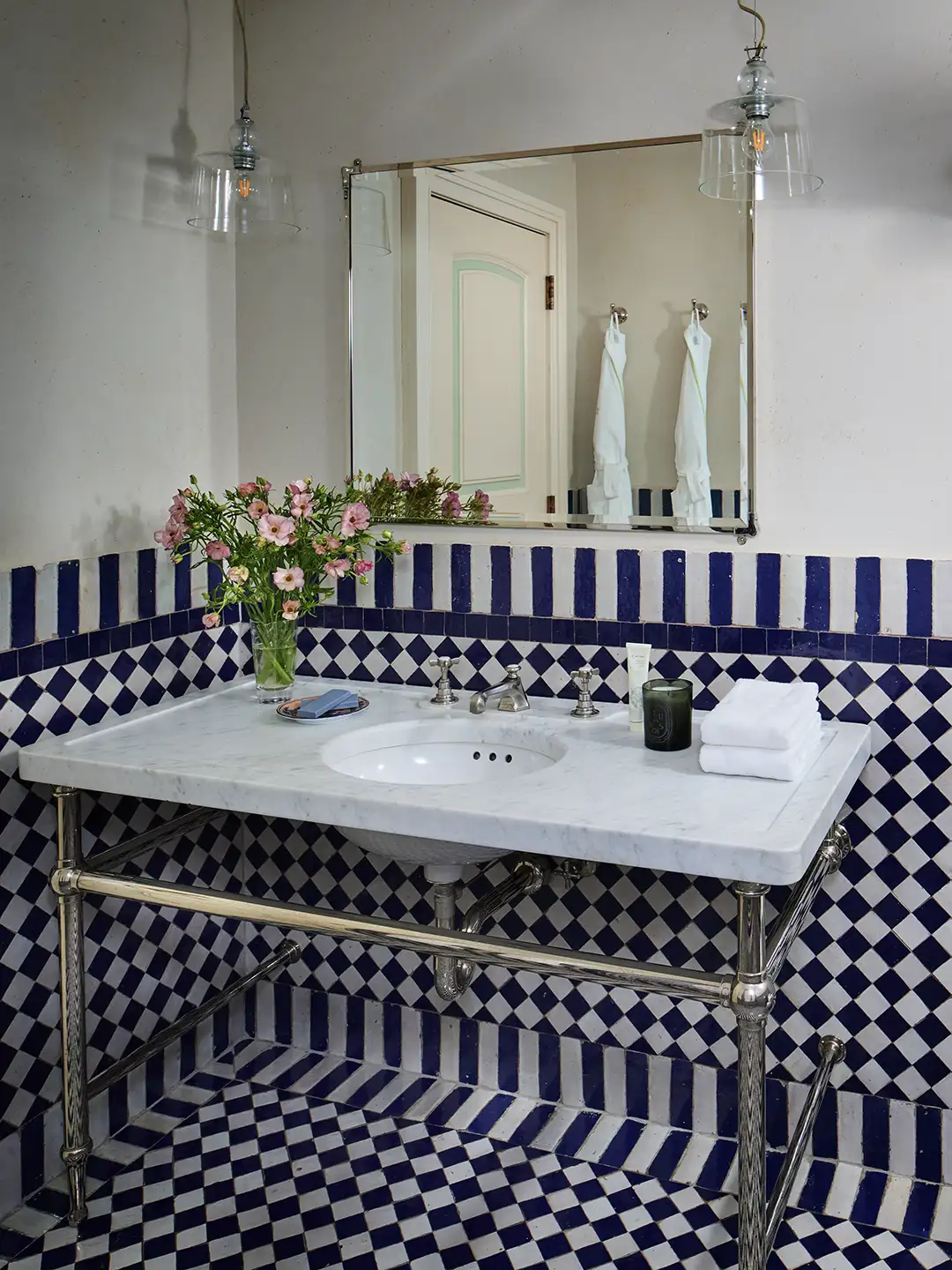 Marble Vanity and blue and white tile in a bathroom at the greenwich hotel
