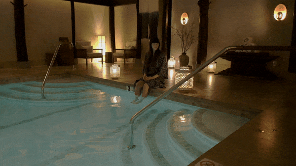 A woman dips her toes in the shallow end of the pool at the Shibui Spa