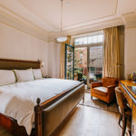 Room view with french doors open to the balcony overlooking Tribeca New York