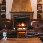 A view of the in-room fireplace and seating area